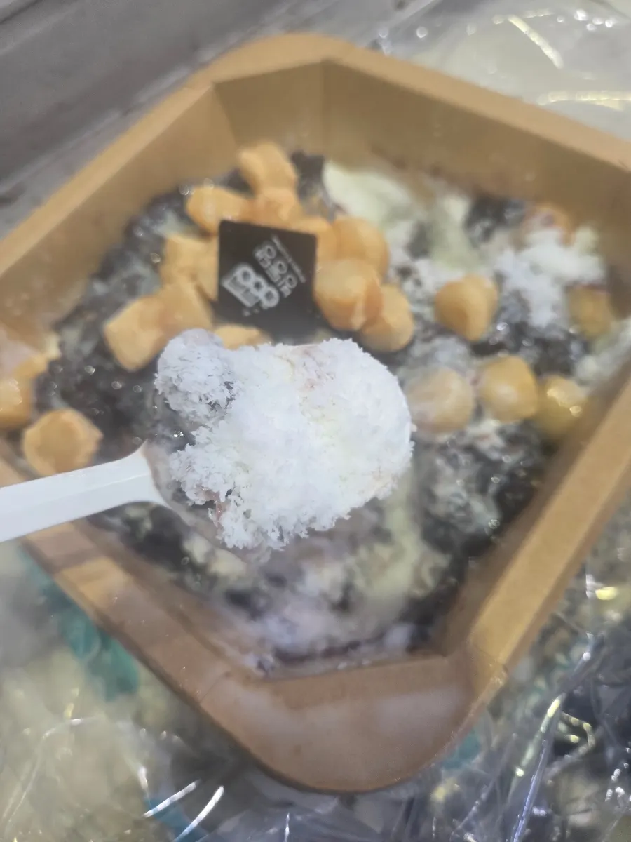 Snow-flake red bean patbingsu topped with red beans, injeolmi rice cake, and logo chocolate