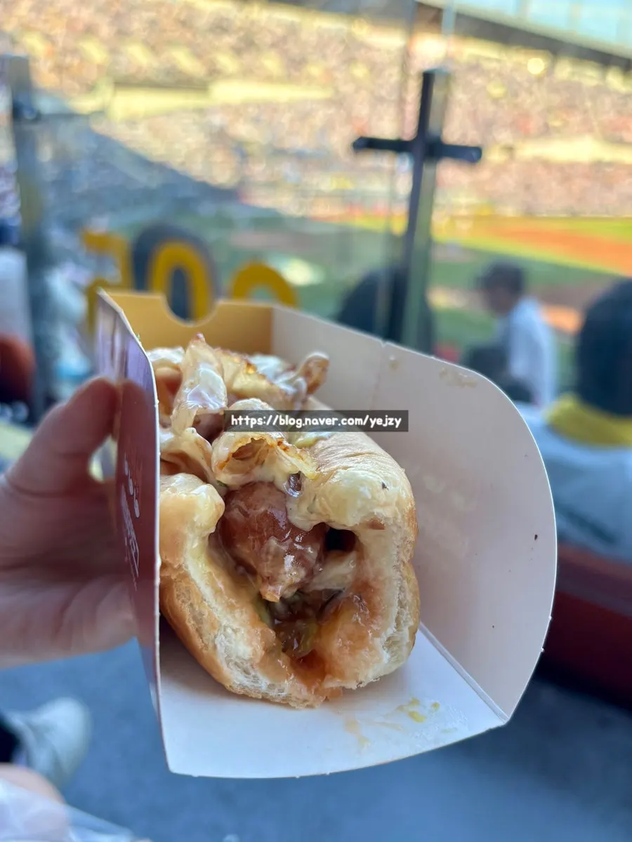 Hot dog topped with bacon, corn, and mayo sauce