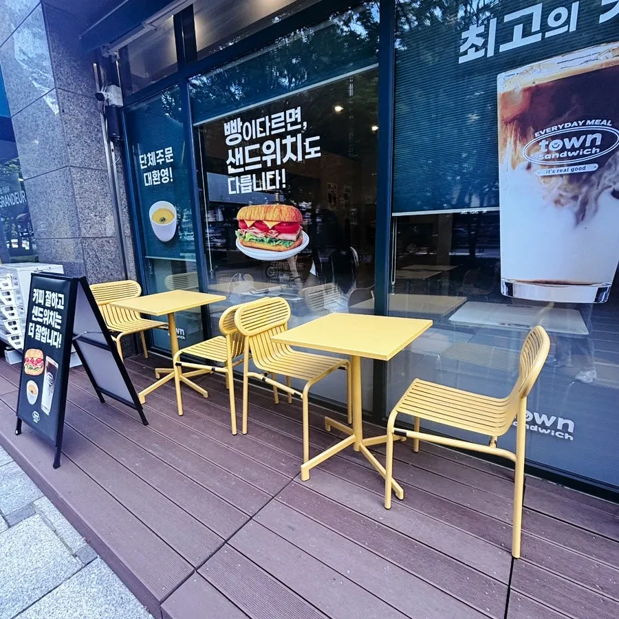 Outdoor tables and signage in front of the shop