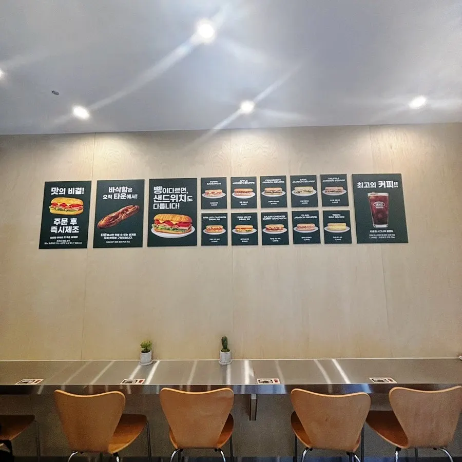 Sandwich and coffee menu posted on the wall