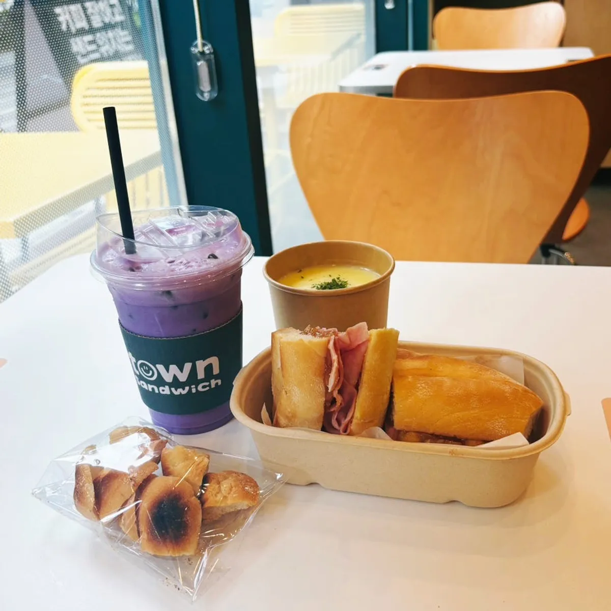 Full spread of apple jambon-beurre, cream soup, and ube latte