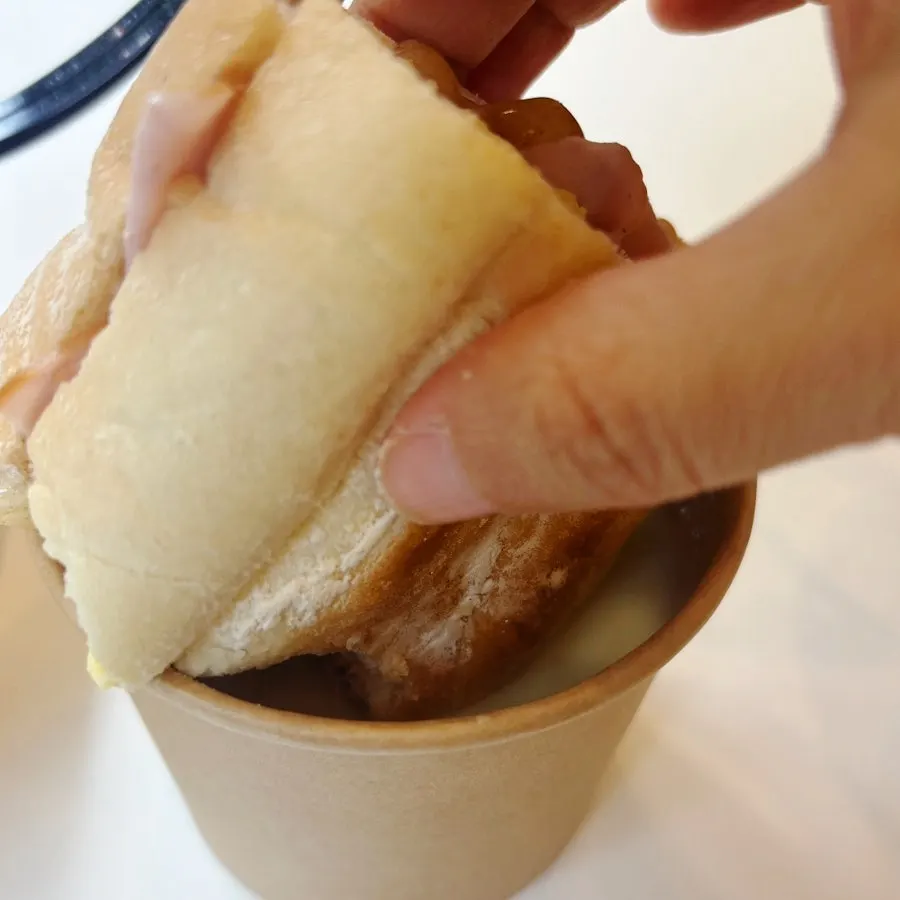 Dipping the baguette into the cream soup