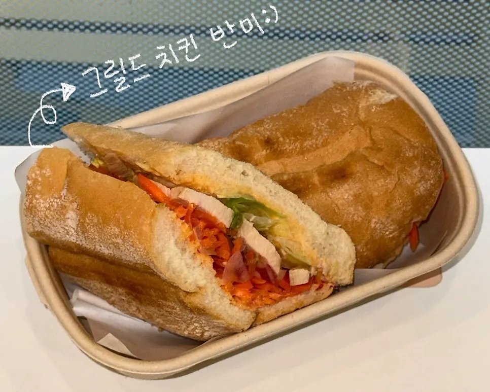 Grilled chicken bánh mì cut into two pieces