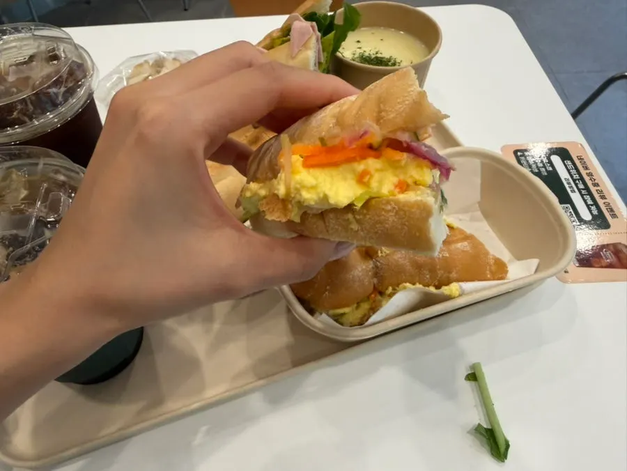 A bite taken out of the baguette sandwich