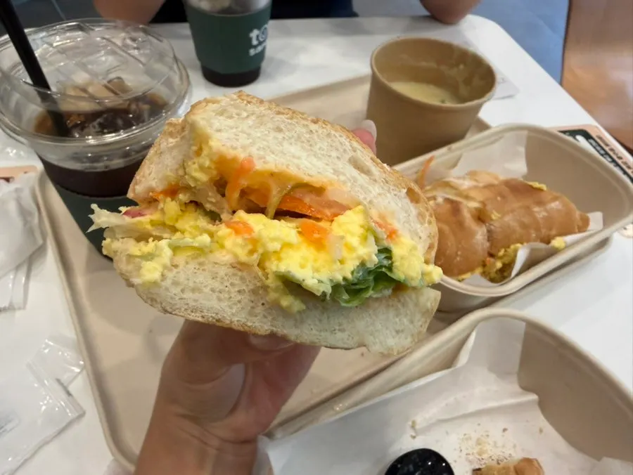 Egg bánh mì and basil jambon-beurre placed side by side on the table