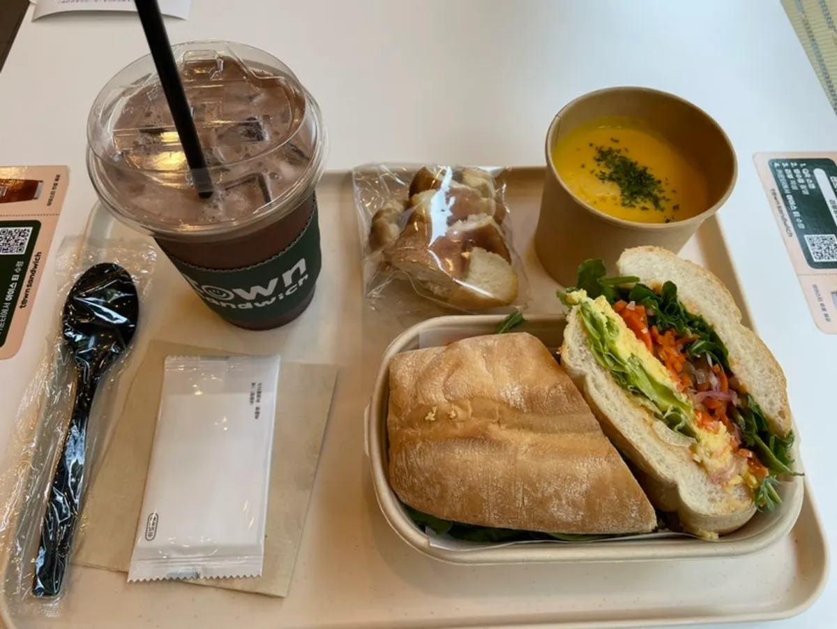 Table spread of egg mayo bánh mì and pumpkin soup