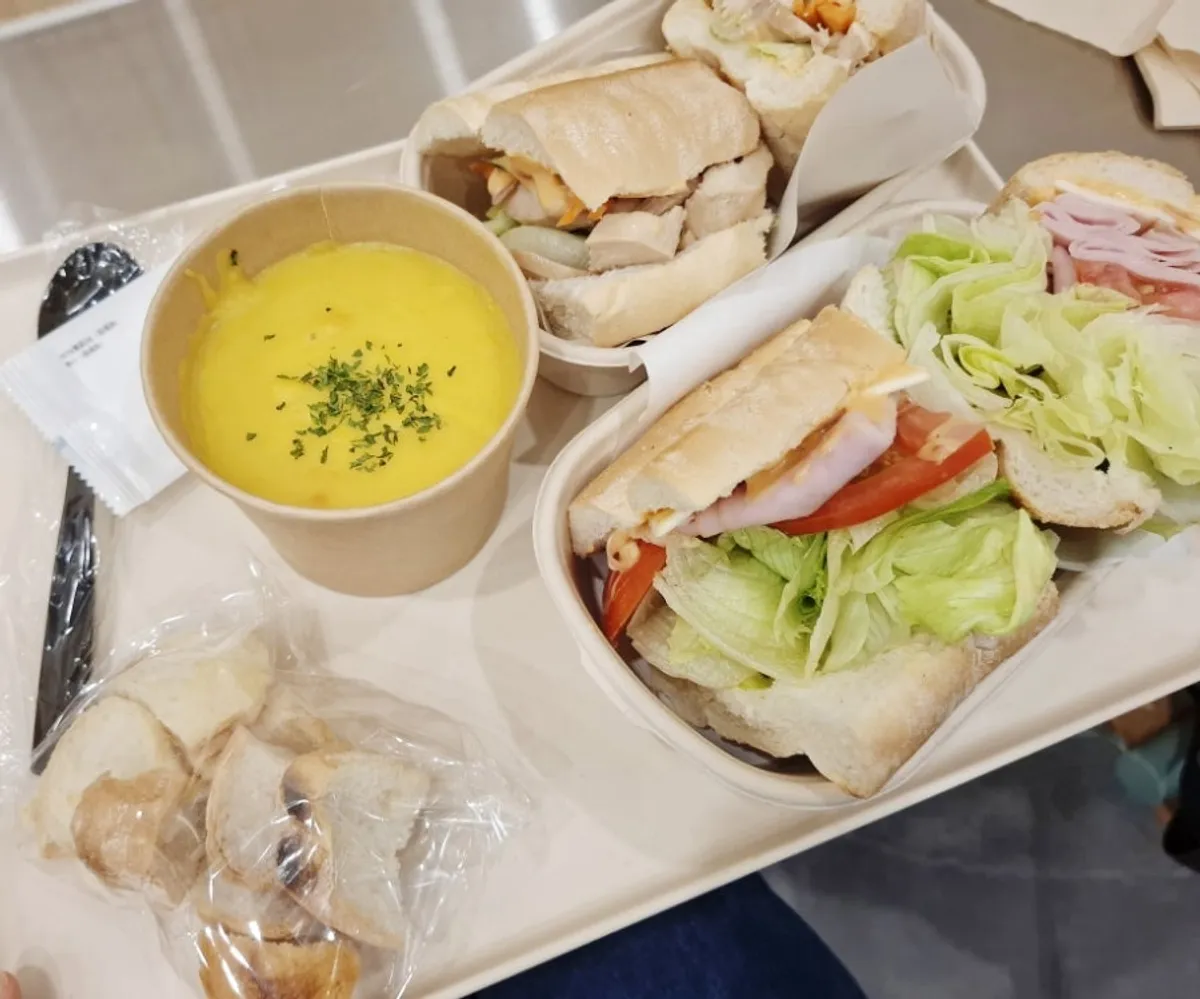 Table spread of Town Sandwich, grilled chicken bánh mì, and pumpkin soup