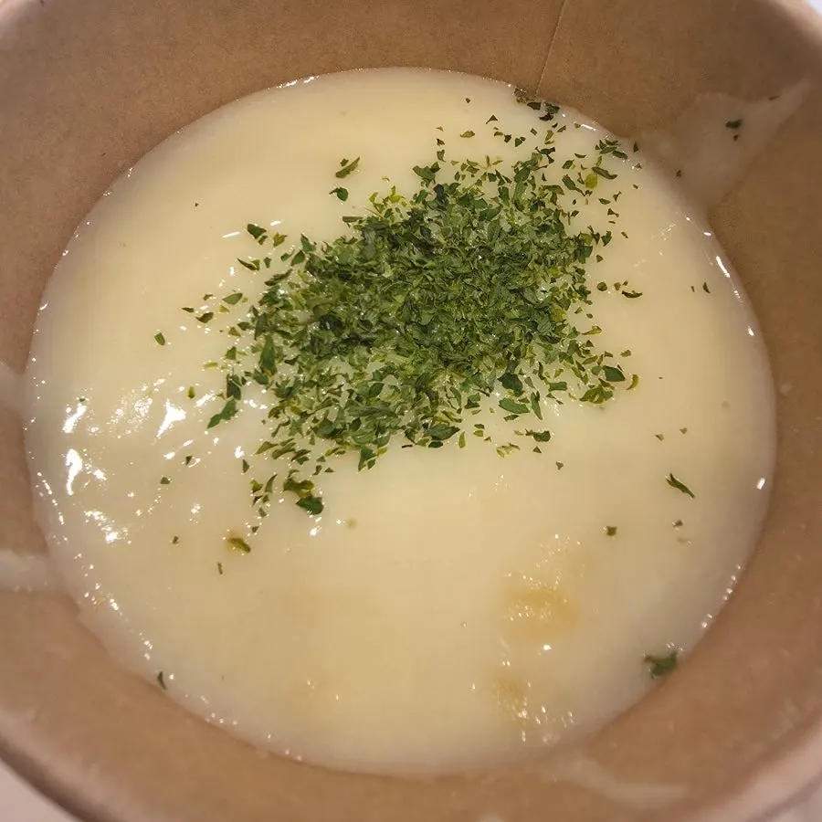 Dipping a baguette into the cream soup