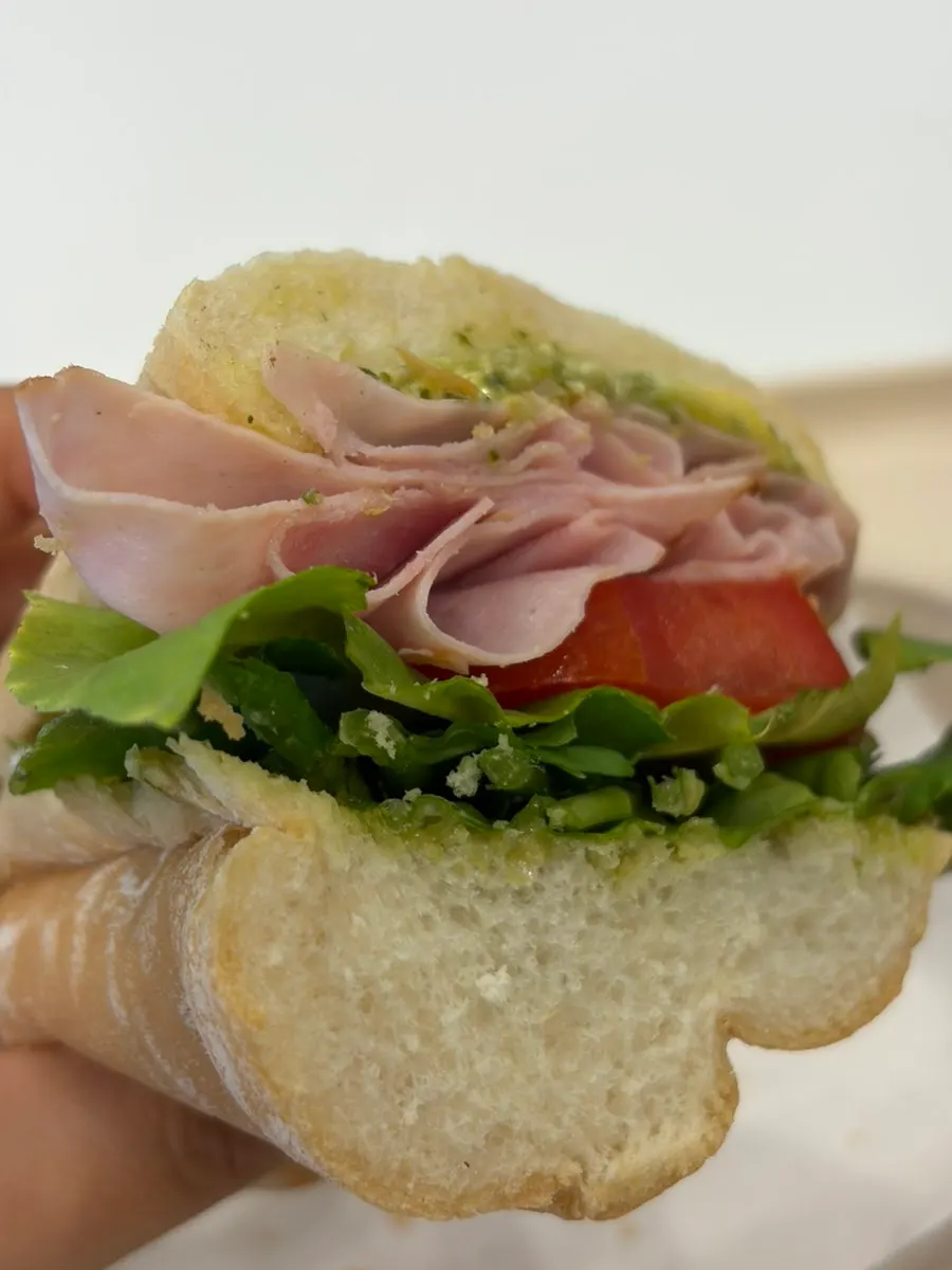 Cross-section packed with rocket, ham, and added tomato