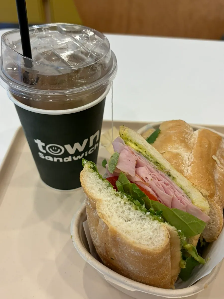 Nearly finished sandwich and drink on the table