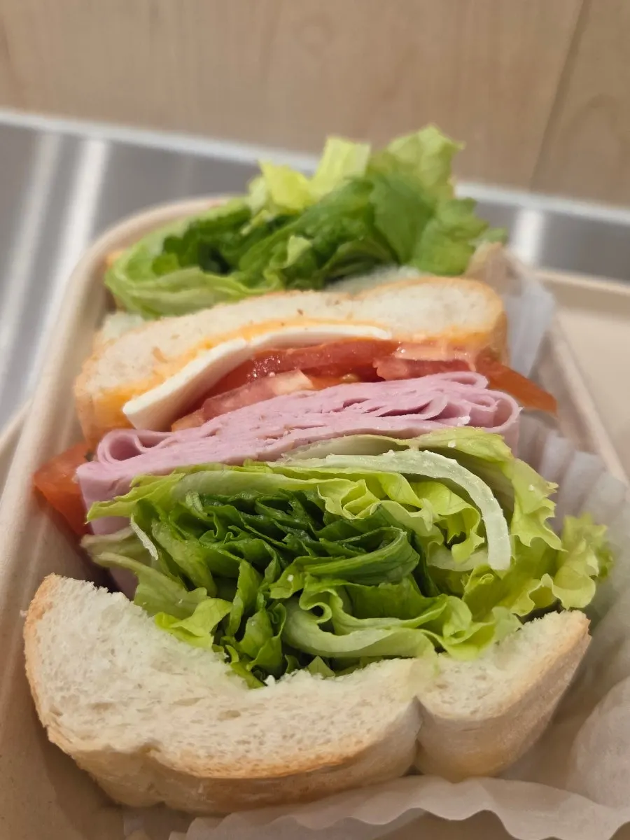 Cross-section of the baguette sandwich with lettuce, ham, and cheese