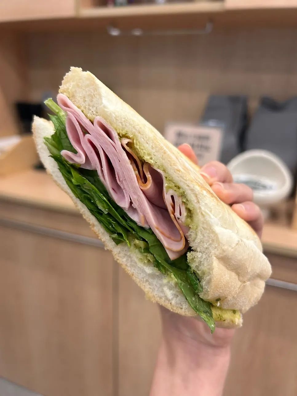 Cross-section of the basil sandwich with jambon-beurre and lettuce in a baguette