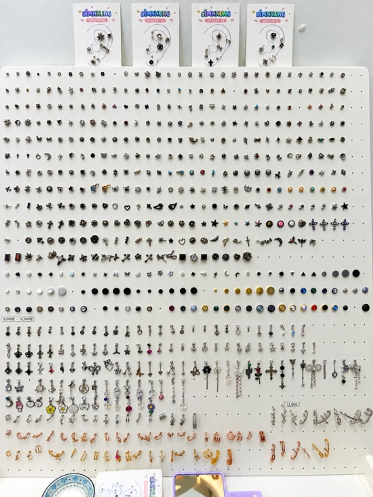 Various piercings displayed on the wall at Simkung Piercing Jamsil