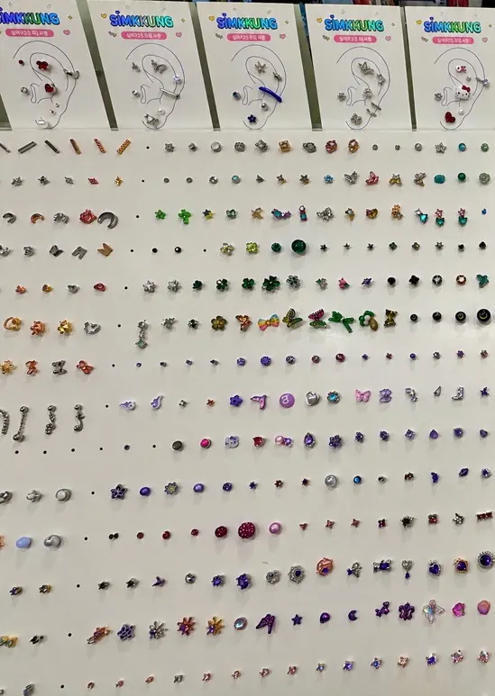 Display case of piercings by design, including cubic, butterfly and ribbon styles