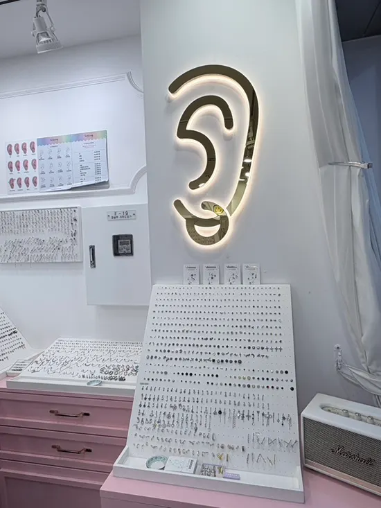 Mini piercings and statement designs for ear styling on display