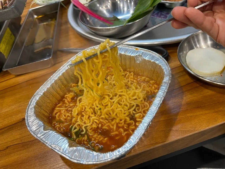 Spicy yeolla ramyeon broth with scallion shreds