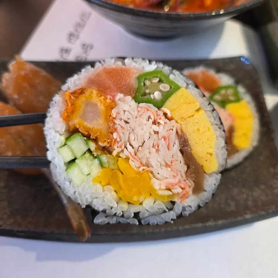 Futomaki with a mix of ingredients and soy-marinated raw shrimp sushi