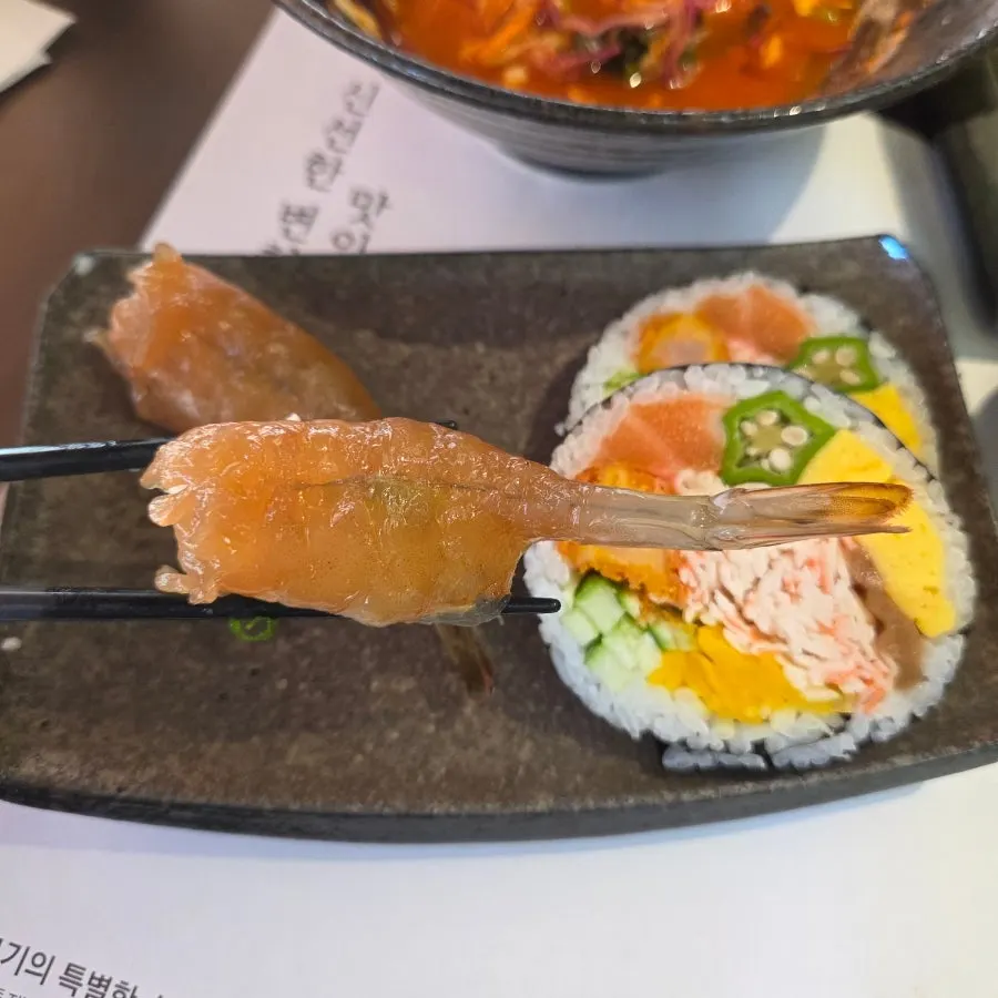 Soy-marinated raw shrimp sushi topped with springy shrimp