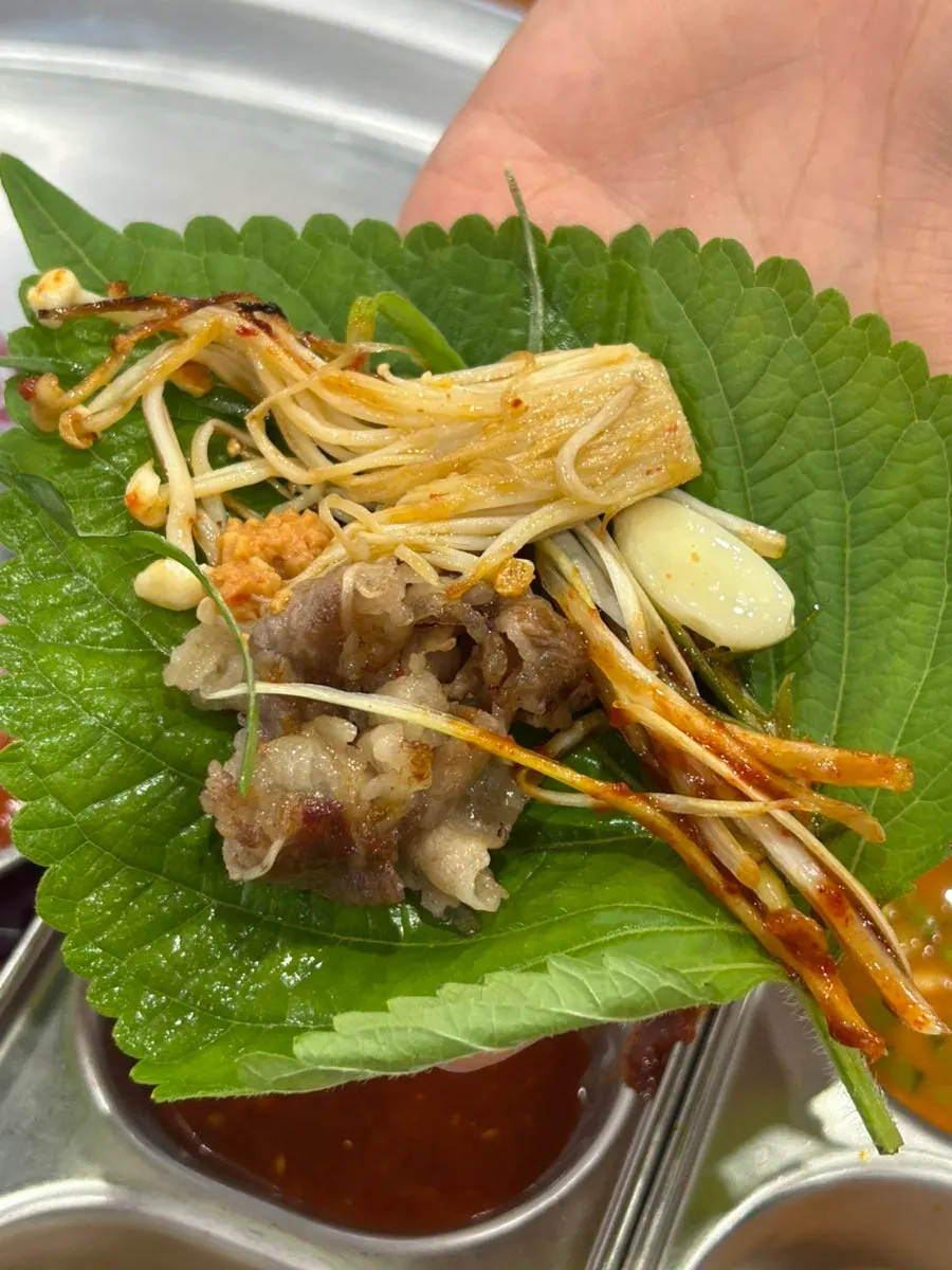 Shaved pork cooking with mushrooms and bean sprouts