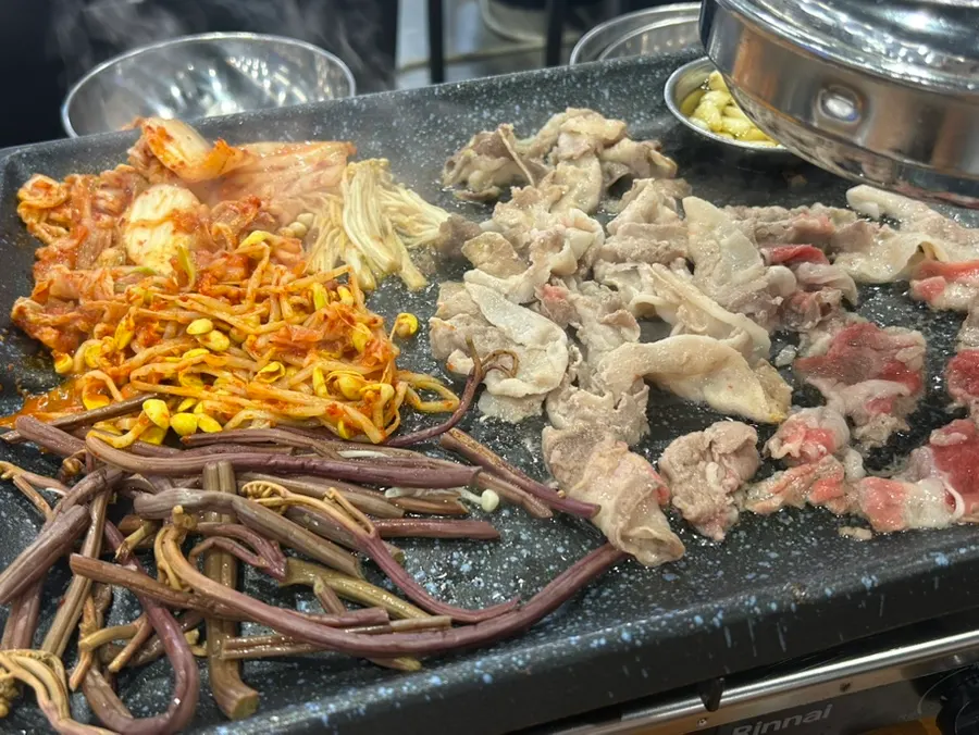 Finished ramen served alongside grilled meat
