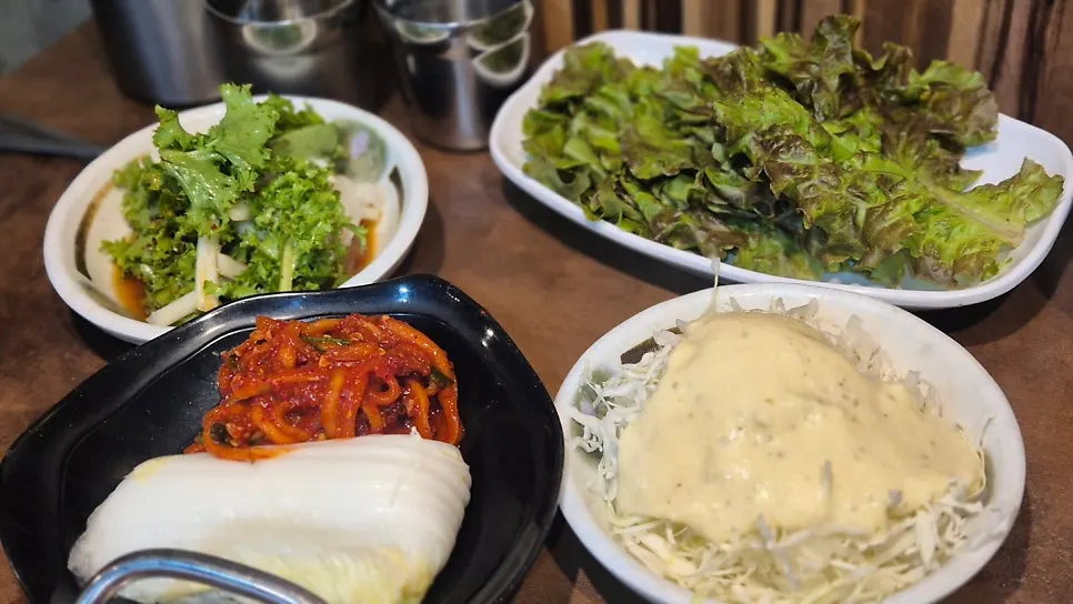 Table setting with marinated crab and complimentary side dishes