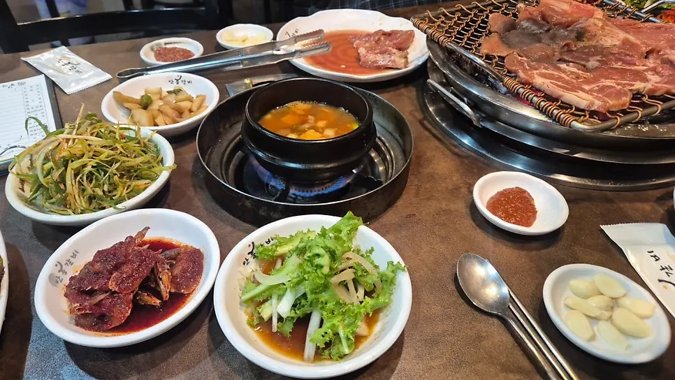 Complimentary side dishes including doenjang stew