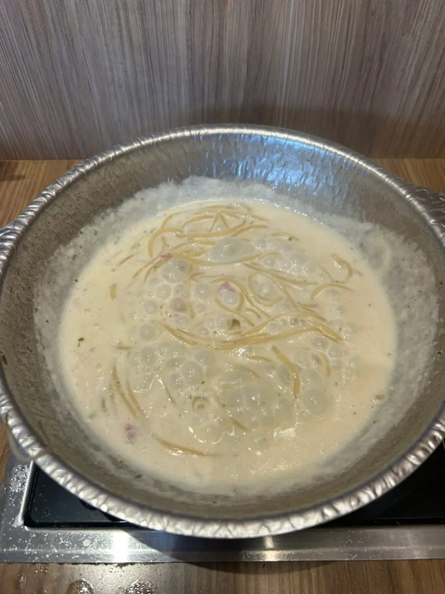 Cream pasta and rosé risotto placed together on the table