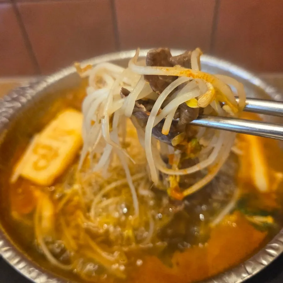 Shabu-shabu meat dipped into chili sauce and soy sauce