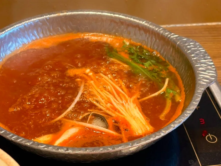 Red broth with spicy sauce added