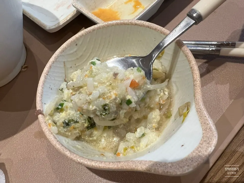 Spoonful of soft porridge lifted from the bowl