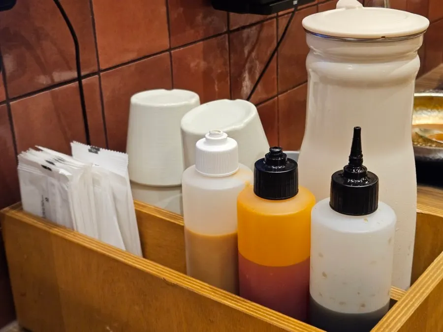 Chili, peanut, and soy sauces for shabu-shabu