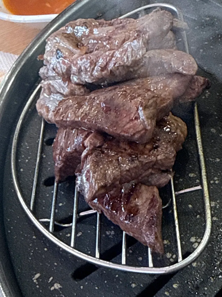 Skirt steak cooking on the high-heat grill