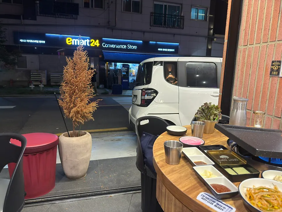 Samgyeopsal and kimchi grilling at the outdoor tent seating