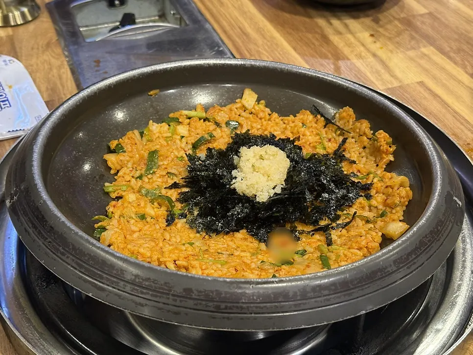 Flying fish roe fried rice being cooked in a round pan