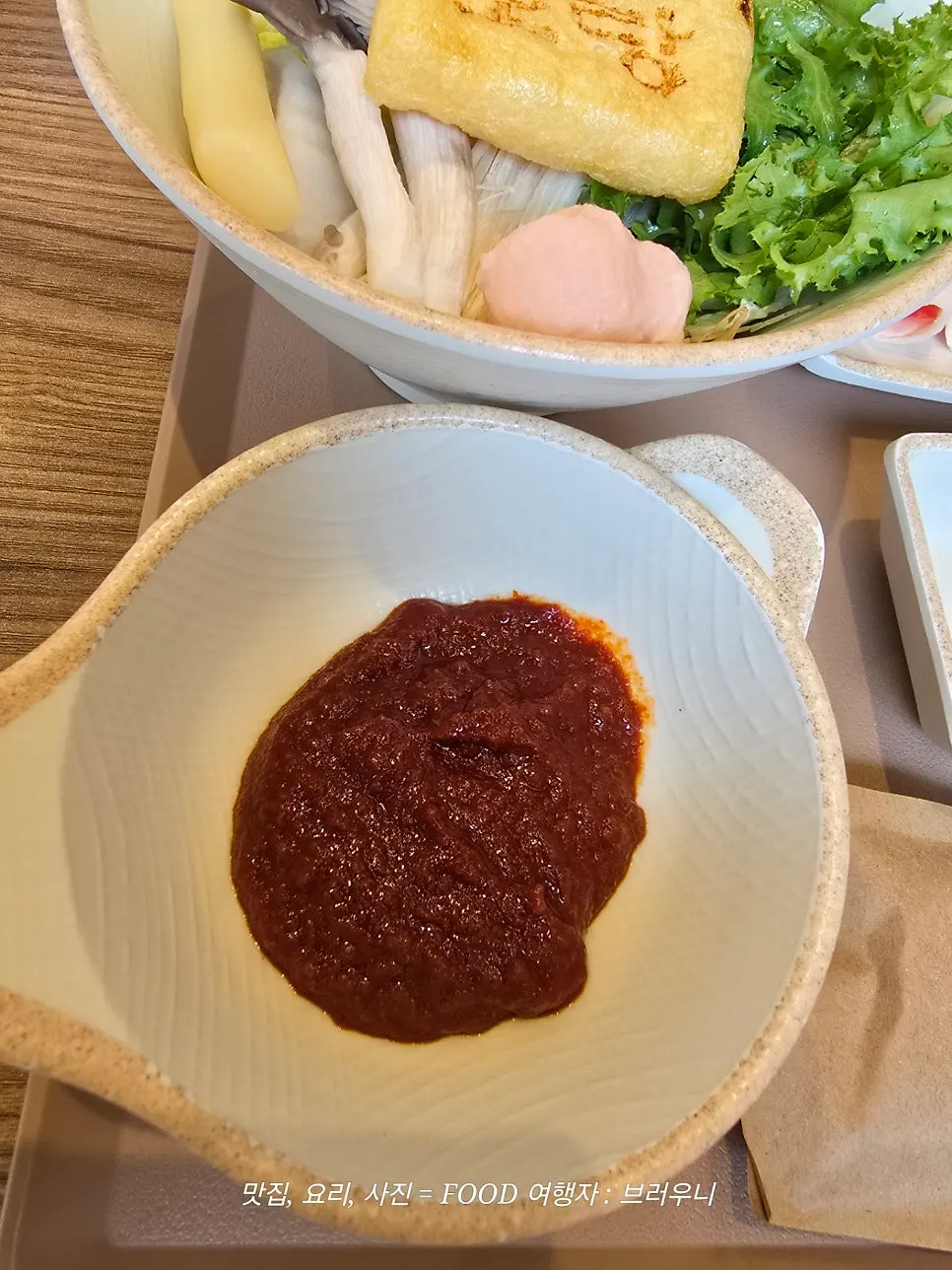 Individual pot with spicy shabu-shabu broth and vegetables