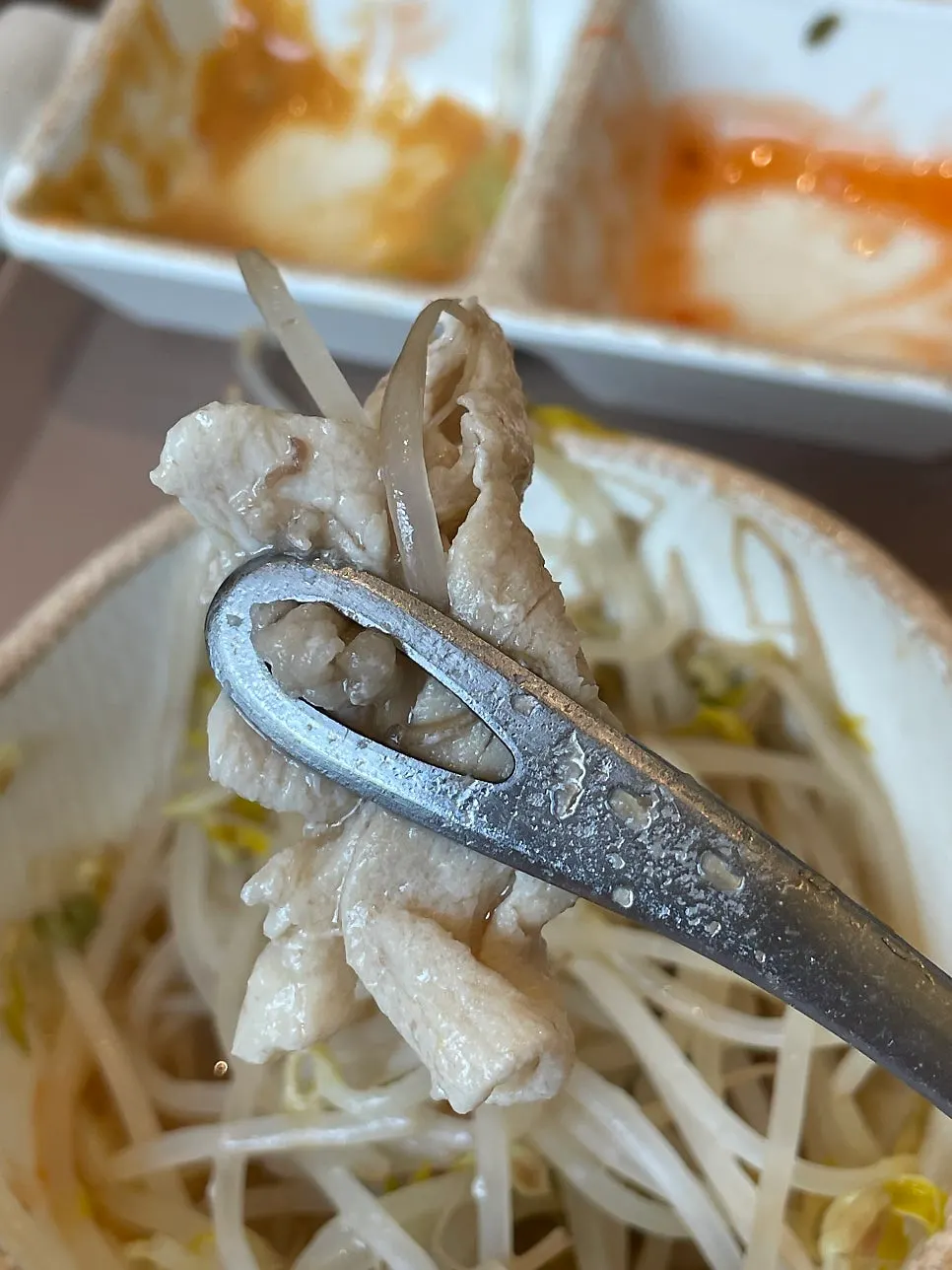 A piece of beef belly dipped in sauce
