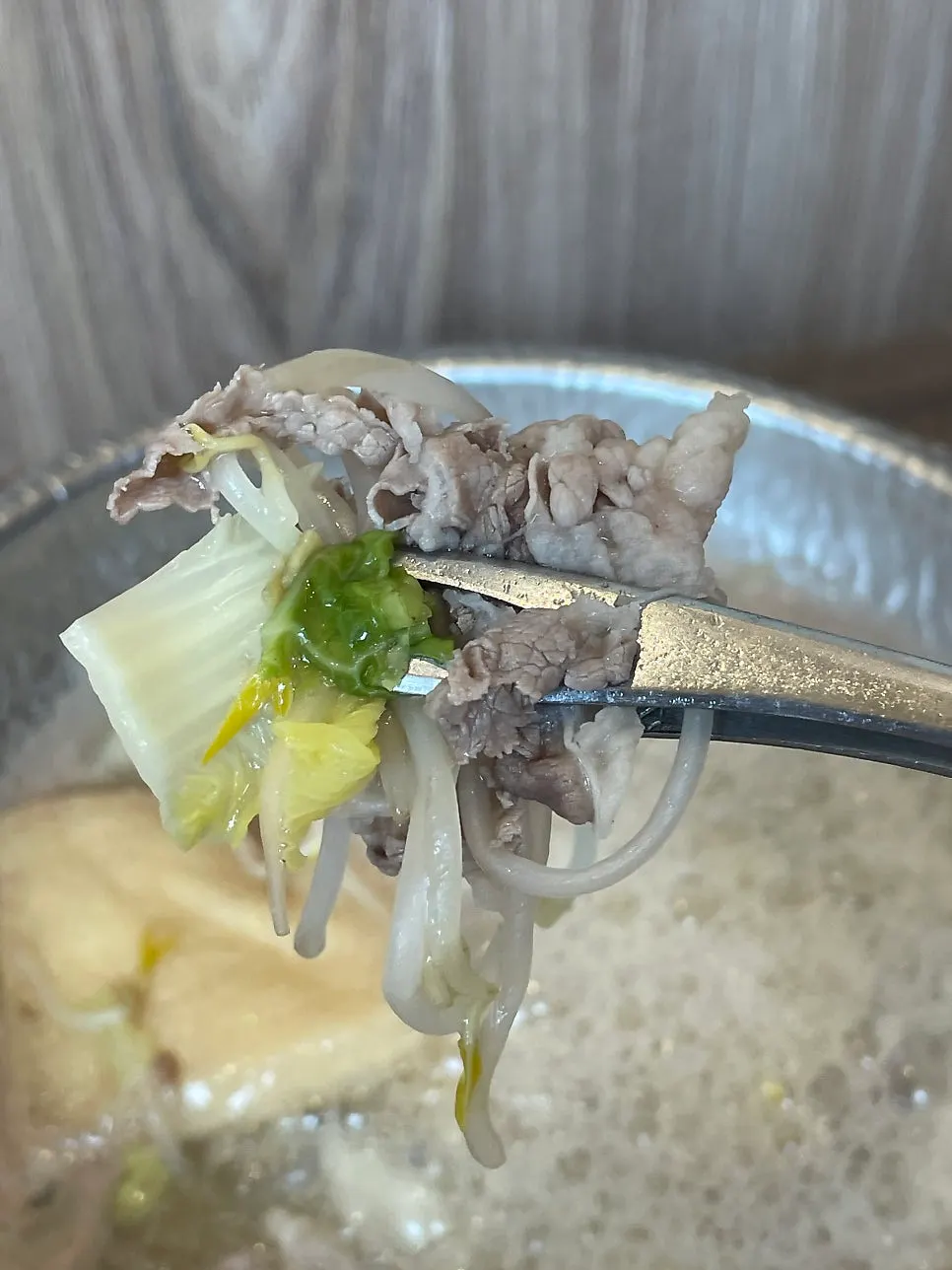 Enoki and oyster mushrooms cooked in the shabu-shabu