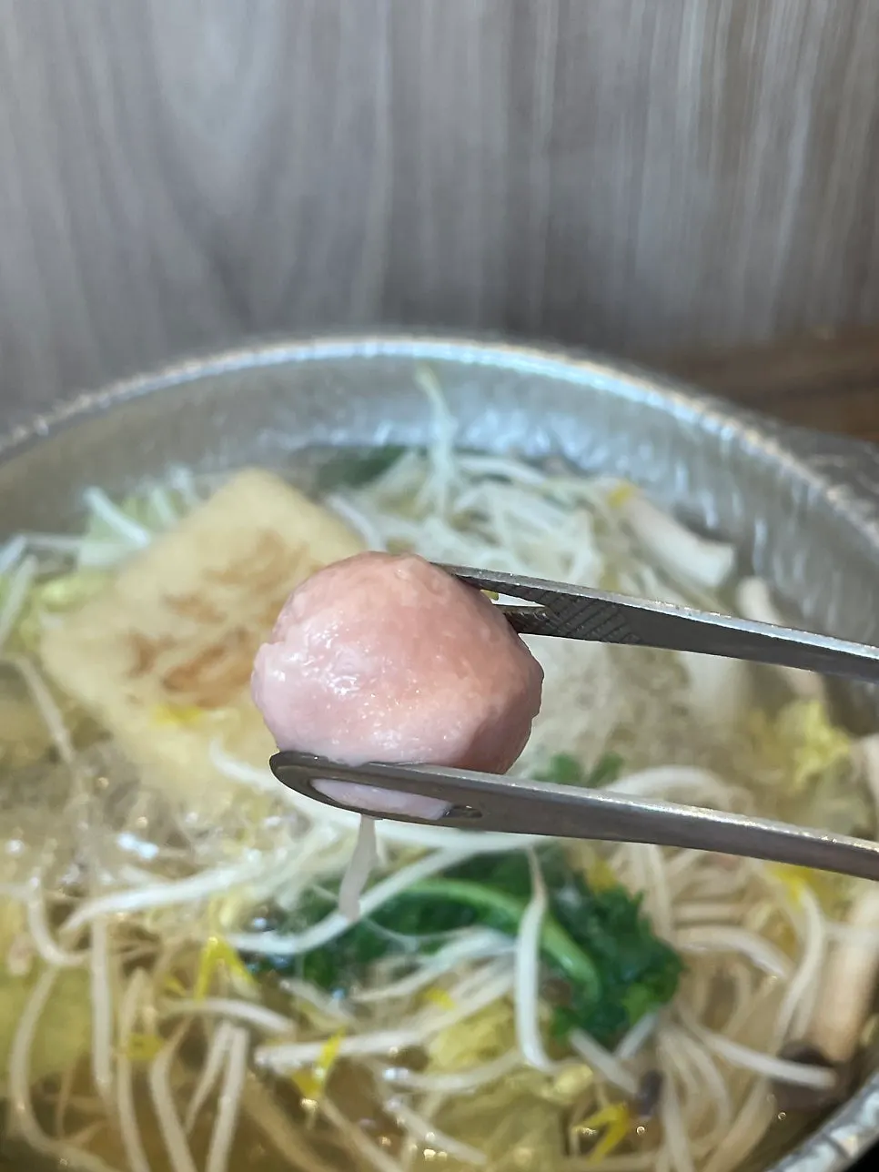 Fish balls being fished out of the pot