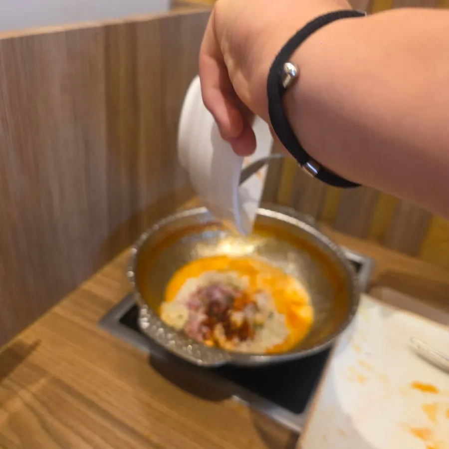 Creamy buldak risotto cooked in the spicy broth