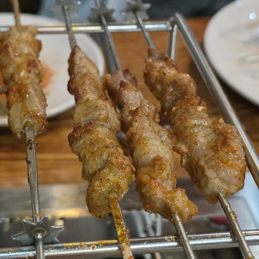 Lamb skewers loaded onto an automatic rotating grill