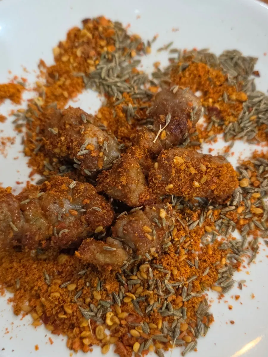 Lamb skewers tossed in seasoning