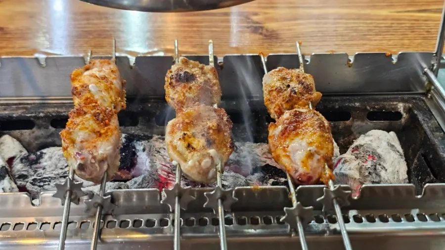 Table with lamb skewers and side dishes