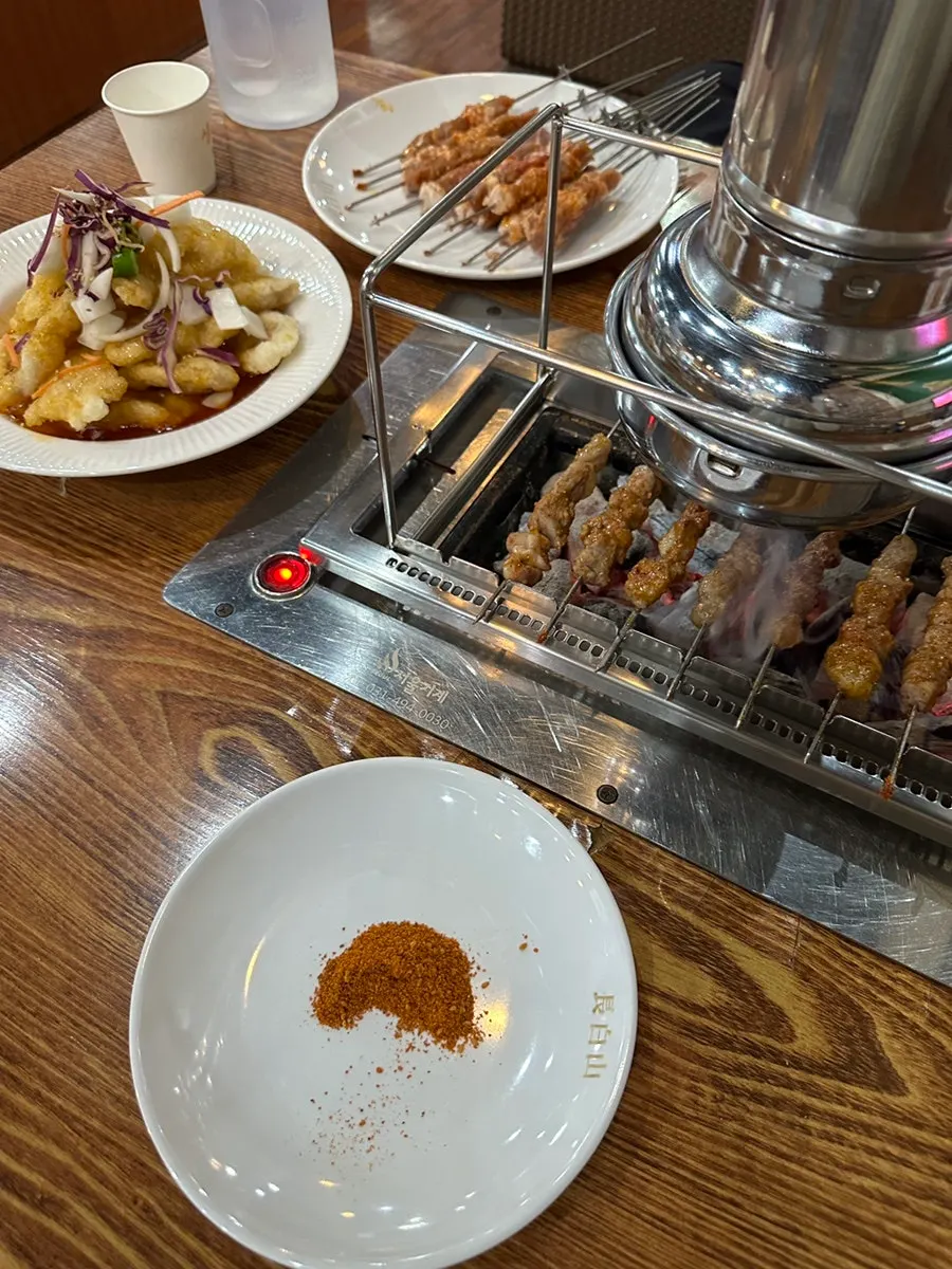 Close-up of lamb skewers grilling to golden brown