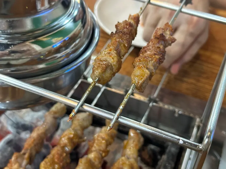 Fully cooked lamb skewers placed on the shelf