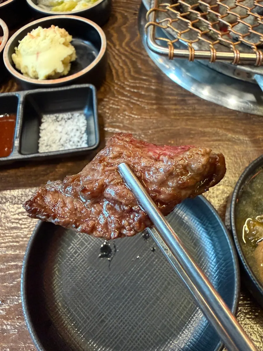 Salt-grilled beef rib cooking on the charcoal
