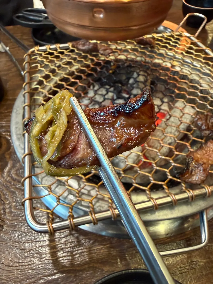 Freshly marinated beef rib grilling on both sides