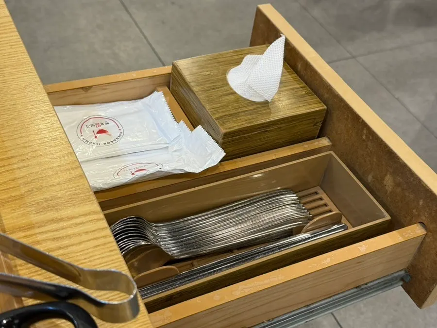 Storage for utensils and wet wipes beneath the table