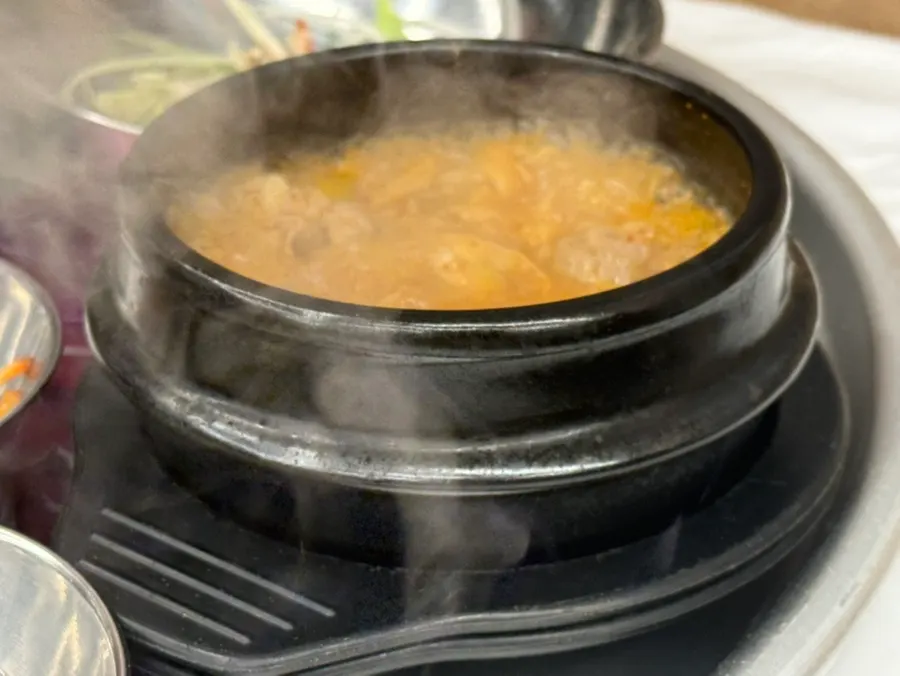 Complimentary doenjang soup in an earthenware pot
