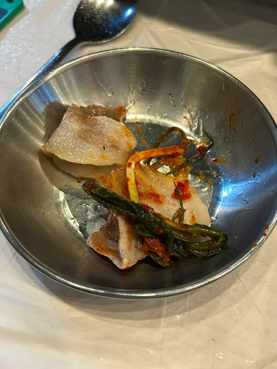 A tender piece of samgyeopsal dipped in ssamjang