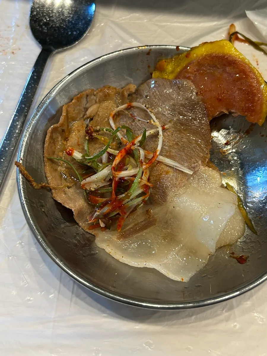Meat wrap topped with green onion strips